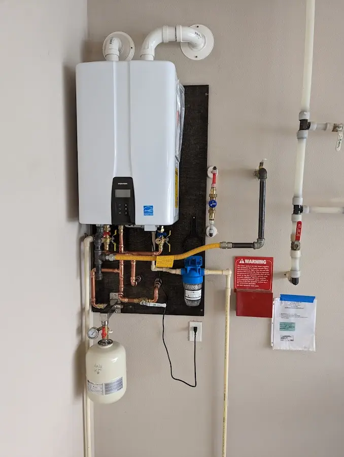 Professional plumber installing copper piping in a Nazareth home